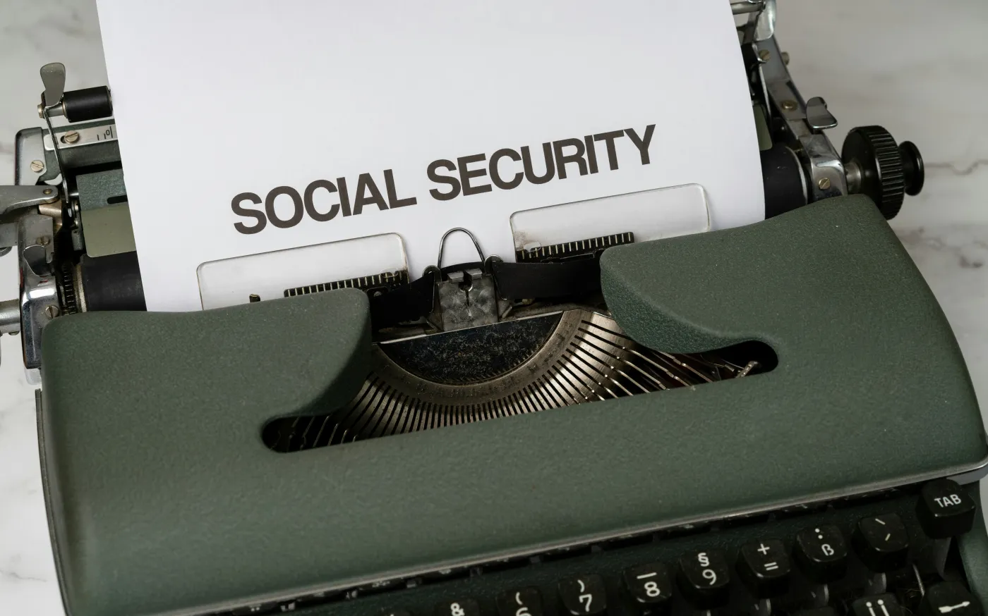 a close up of a typewriter with a paper that says social security by Markus Winkler courtesy of Unsplash.