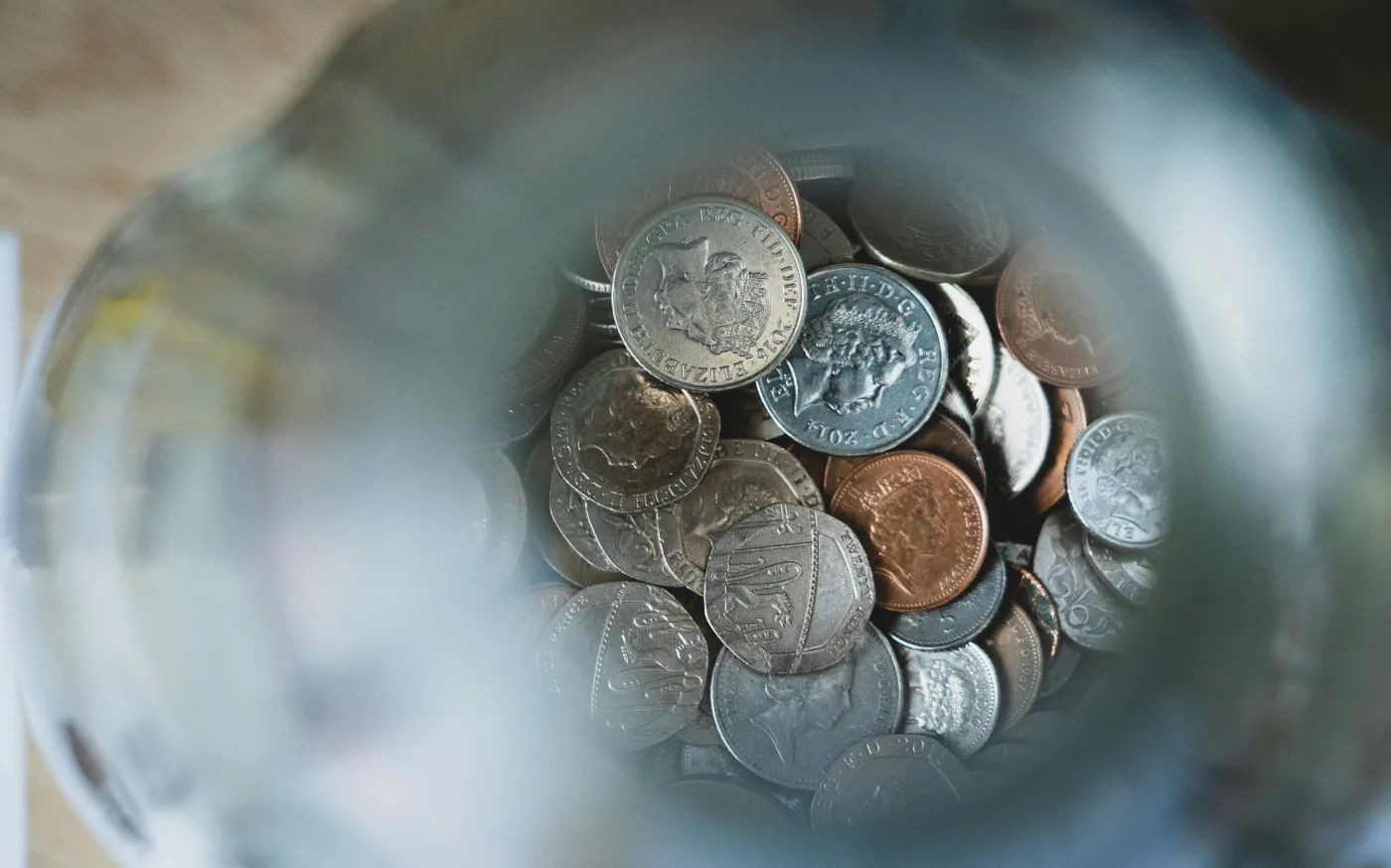 silver round coins on blue round container by Nick Fewings courtesy of Unsplash.