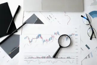 magnifying glass on top of a financial chart