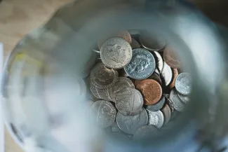silver round coins on blue round container by Nick Fewings courtesy of Unsplash.
