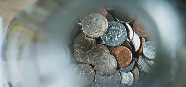 silver round coins on blue round container by Nick Fewings courtesy of Unsplash.