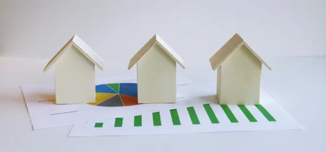 three small houses sitting on top of a piece of paper by Artful Homes courtesy of Unsplash.